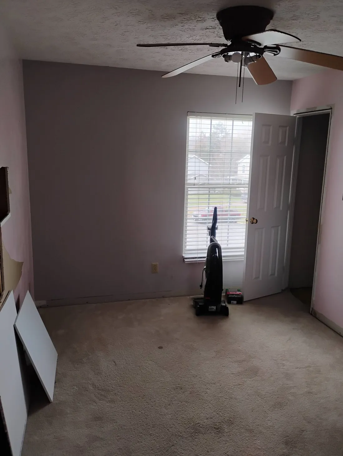 Bedroom before painting with mauve walls and a dated finish